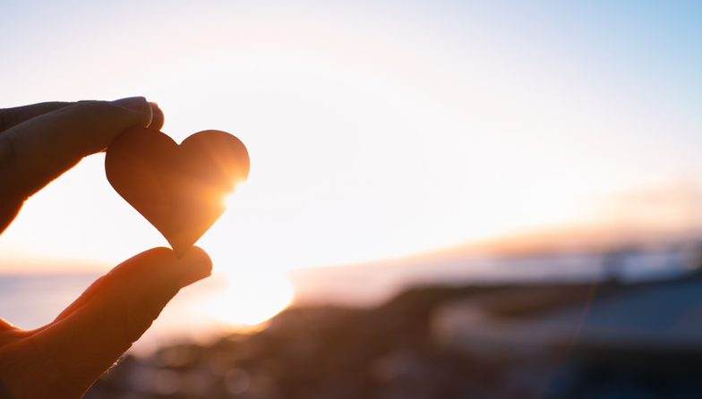 Hand holding here in the sunset. I love nature concept - stock photo