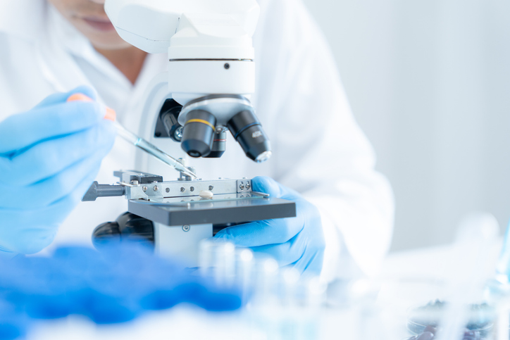 Scientist using a microscope for medical research