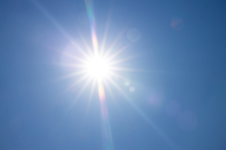  Full bright sun with blue sky - stock photo