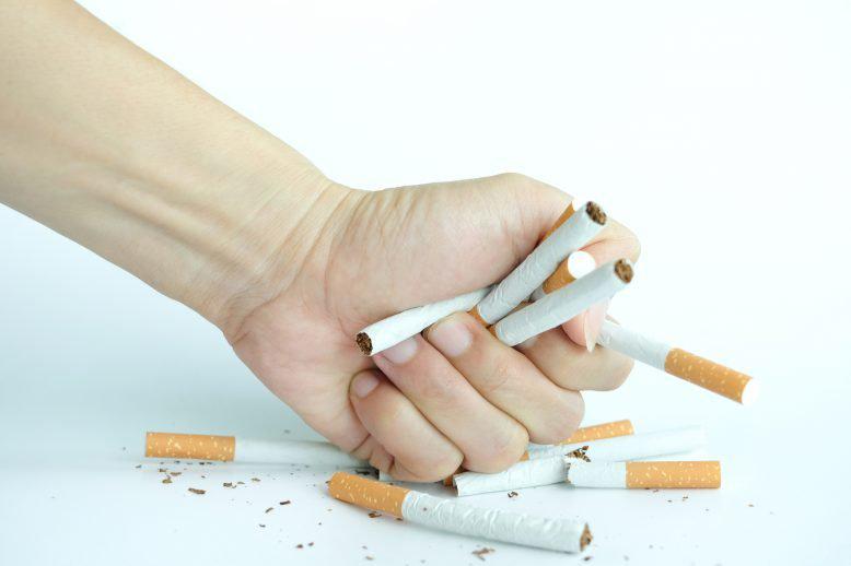 Hand crushing cigarettes