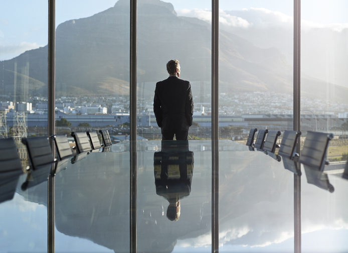 CEO gazing outside of office building window