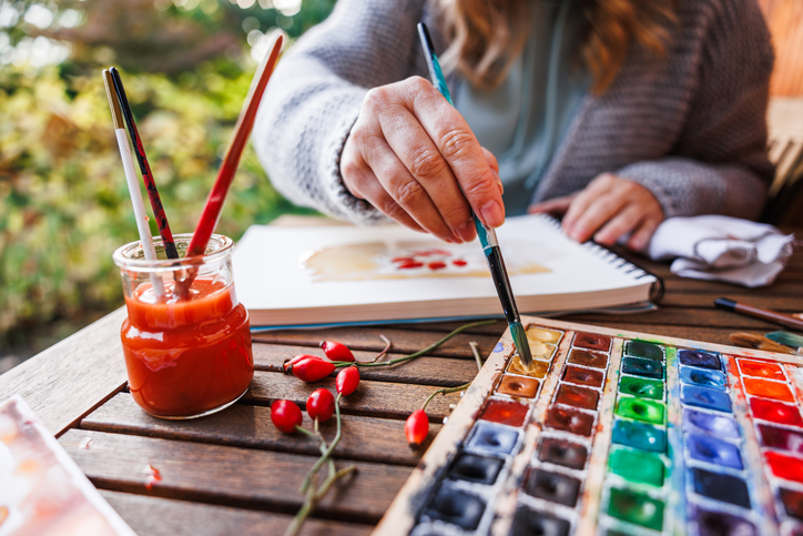 women painting outside