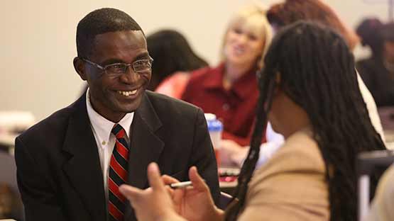 Two adult learners in conversation with each other