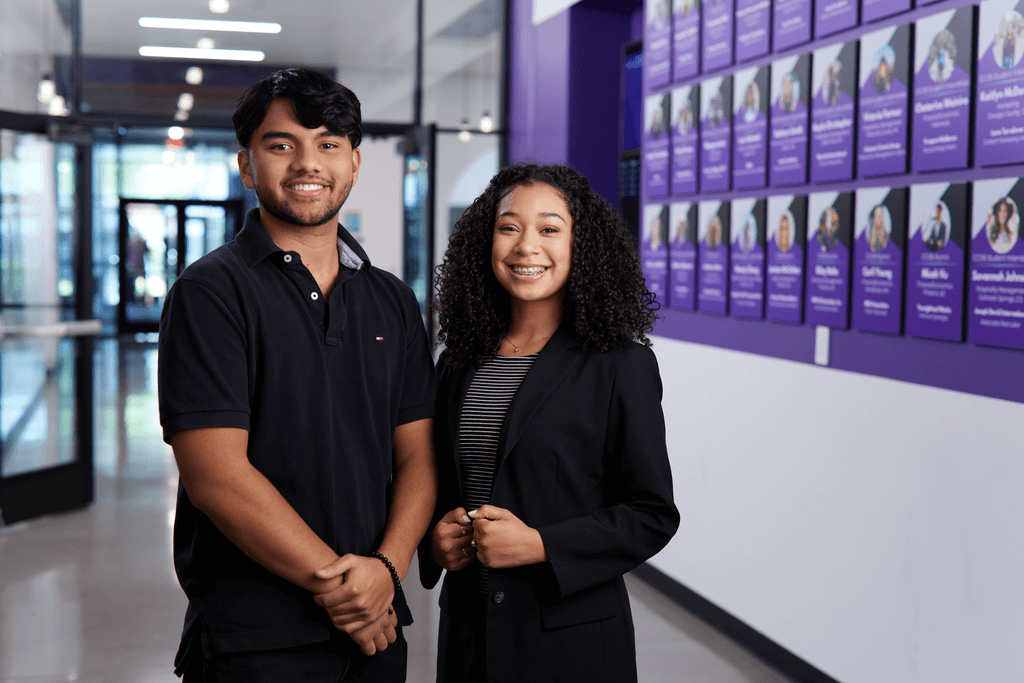 Male and female business degree students smiling in GCU's business college